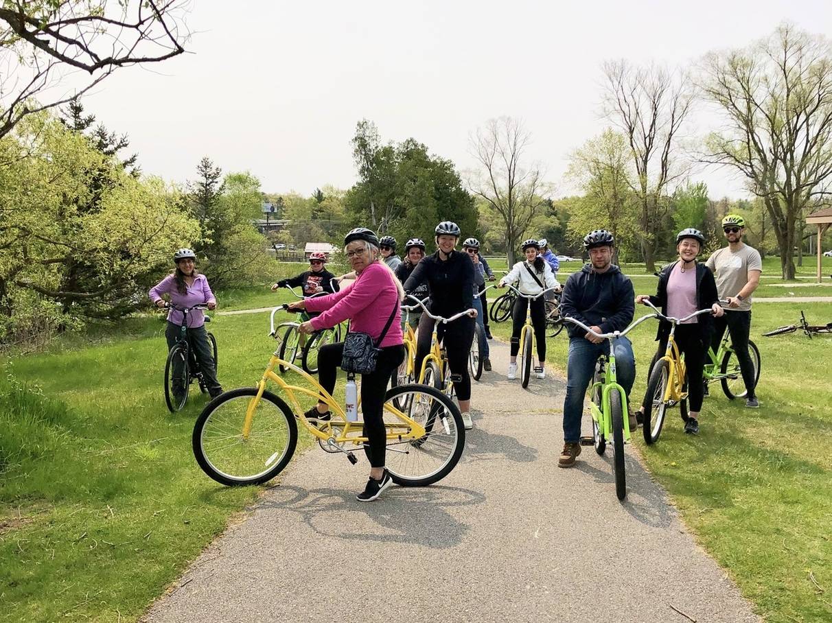 a group of people still, posing on their bikes